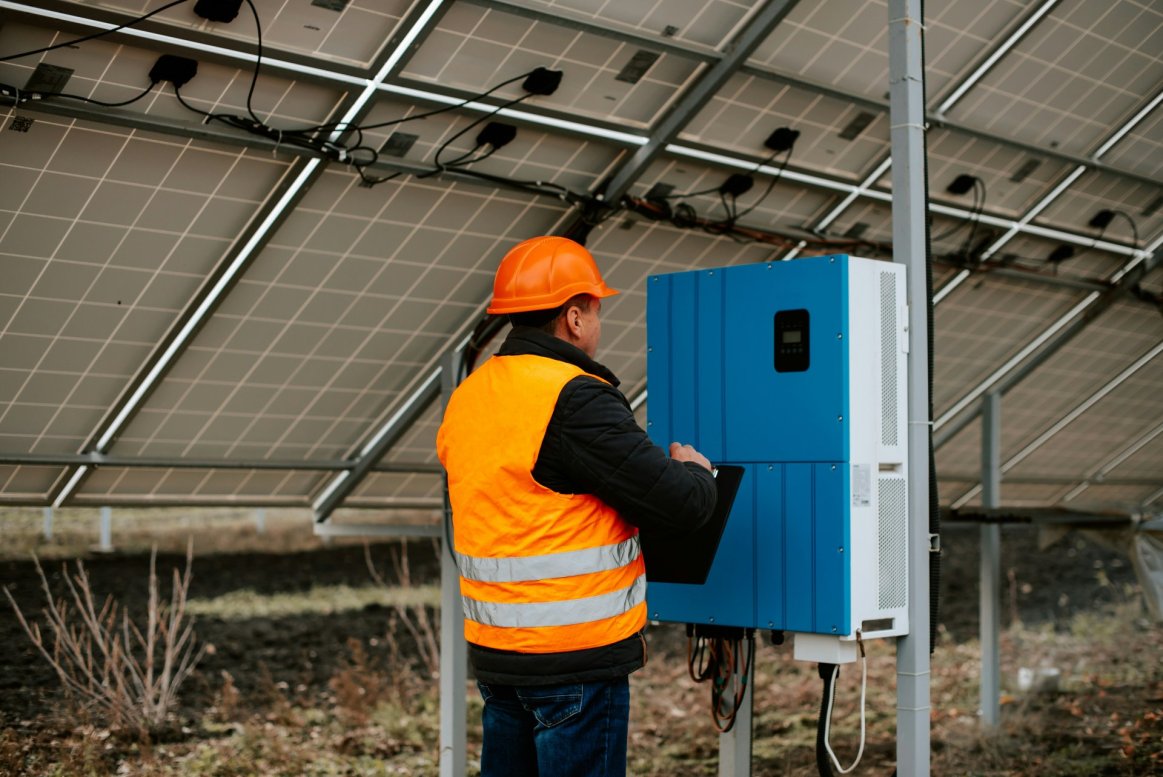 Solar installer checking solar battery bank.