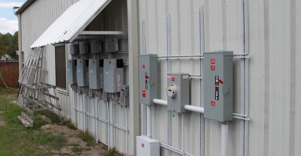 47 kW Corrugated Roof Installation for the Gainesville, FL Feed in Tariff View of inverters in full commercial installation project.